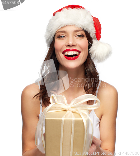 Image of woman with gift box in santa hat at christmas