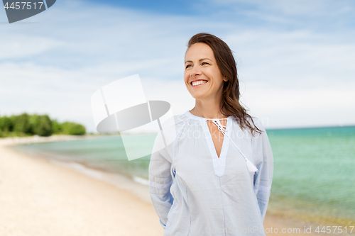 Image of happy smiling woman on summer beach