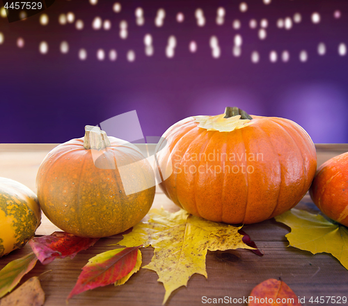 Image of close up of pumpkins on wooden table