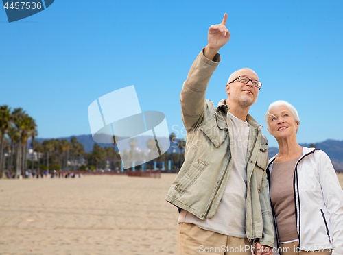 Image of happy senior couple over venice beach background
