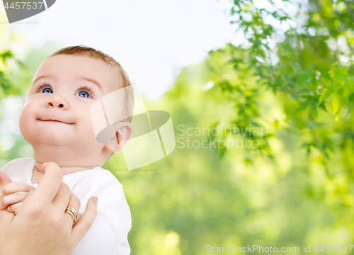 Image of close up of sweet little baby with mother hand