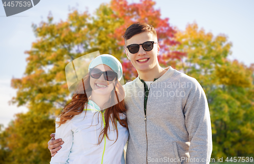 Image of happy teenage couple in autumn park