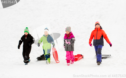 Image of happy little kids with sleds in winter