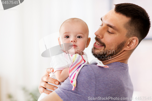 Image of father with little baby girl at home