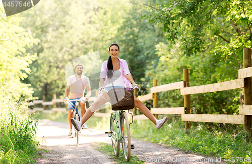 Image of happy couple with bicycles at summer park