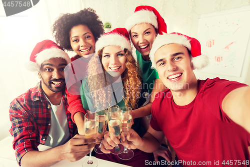 Image of happy team celebrating christmas at office party