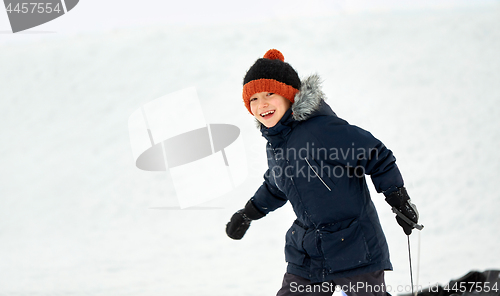 Image of happy little boy with sled in winter outdoors