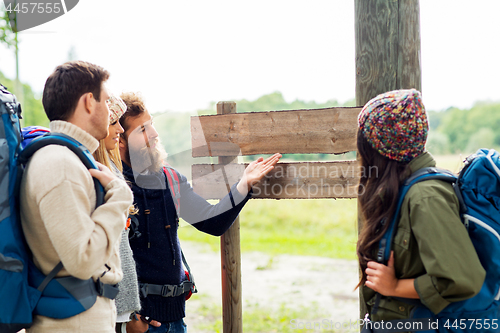 Image of hiking friends with backpacks at signpost