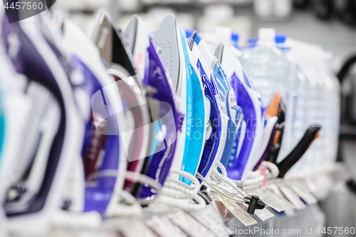 Image of row of electric irons in retail store
