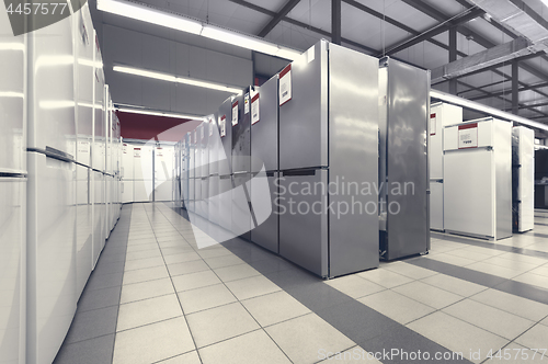 Image of rows of refrigerators in appliance store