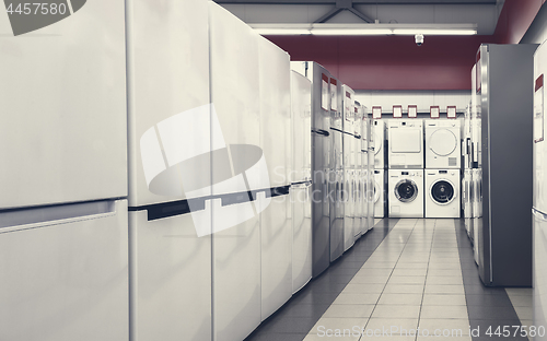 Image of refrigerators and washing mashines in appliance store