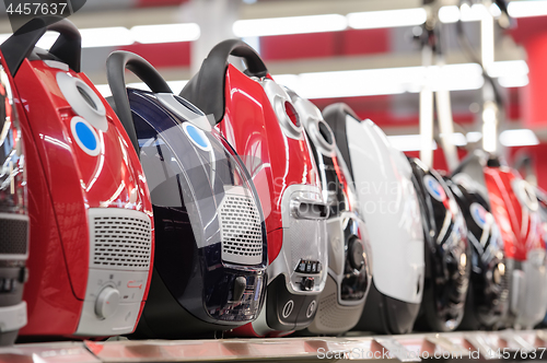 Image of Row of vacuum cleaners in appliance store