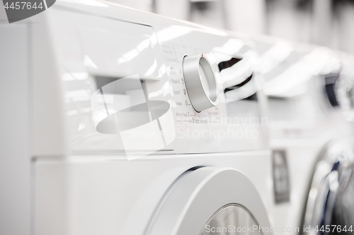 Image of washing mashines closeup in appliance store