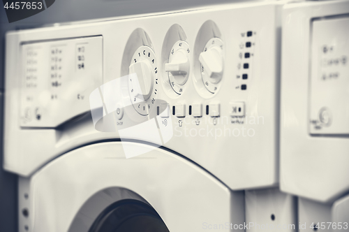 Image of washing mashines closeup in appliance store