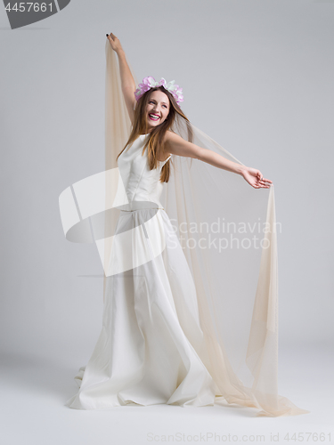 Image of young bride in a wedding dress with a veil