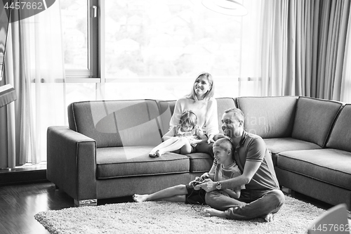 Image of Happy family playing a video game