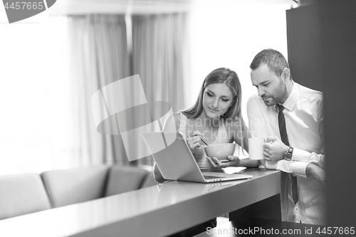 Image of A young couple is preparing for a job and using a laptop
