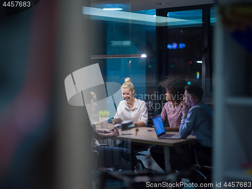 Image of Multiethnic startup business team in night office