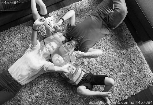 Image of happy family lying on the floor