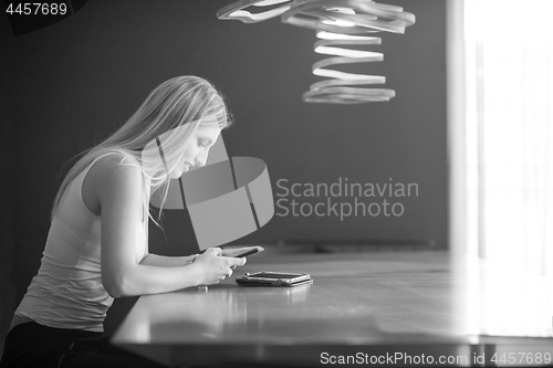 Image of young woman using mobile phone