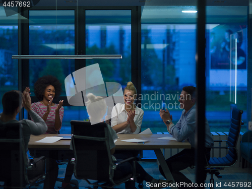 Image of Multiethnic startup business team in night office