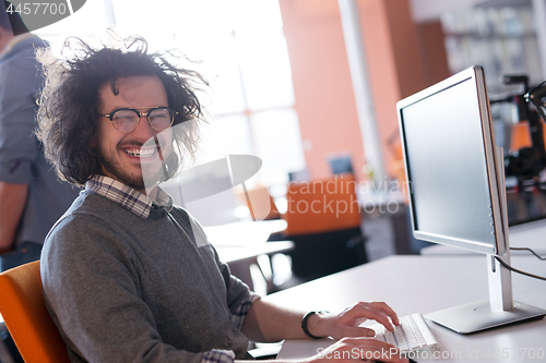 Image of businessman working using a computer in startup office