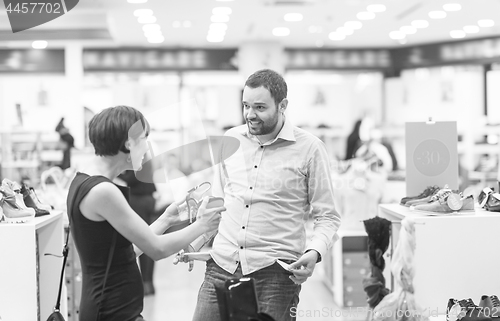 Image of couple chooses shoes At Shoe Store