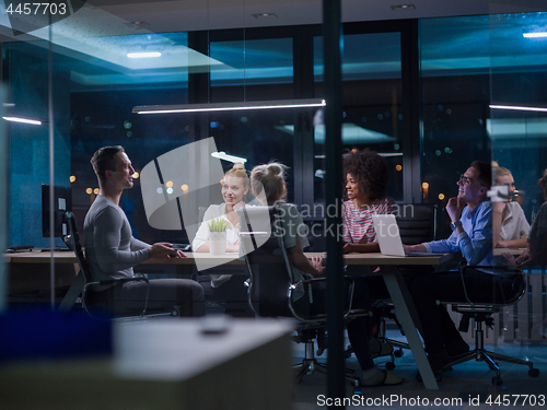 Image of Multiethnic startup business team in night office