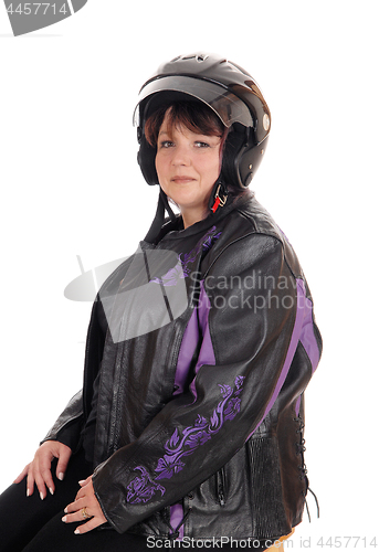 Image of Smiling woman with helmet and jacket