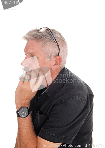 Image of Middle aged man with hand on chin