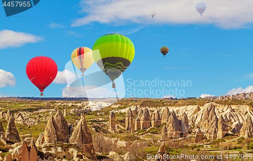 Image of Hot air baloons flying over spectacular stone cliffs in Cappadocia