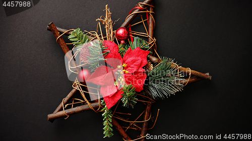 Image of Christmas wreath with dry twigs, pine branches, red balls