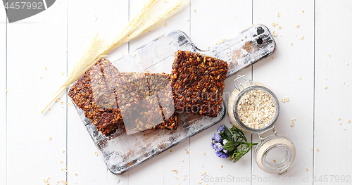 Image of Closeup of whole grain bread with sunflower seeds on a rustic wooden board