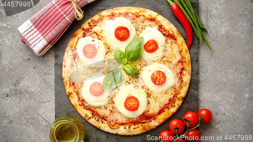 Image of Homemade pizza with tomatoes, mozzarella