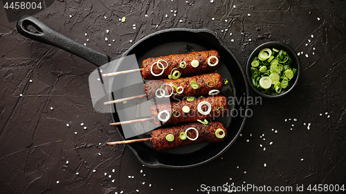 Image of Barbecued turkey kebab decorated with fresh onion