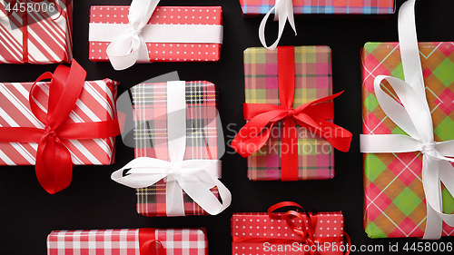 Image of Top view of wrapped Christmas presents laid on the black background