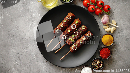 Image of Barbecued turkey kebab decorated with fresh onion