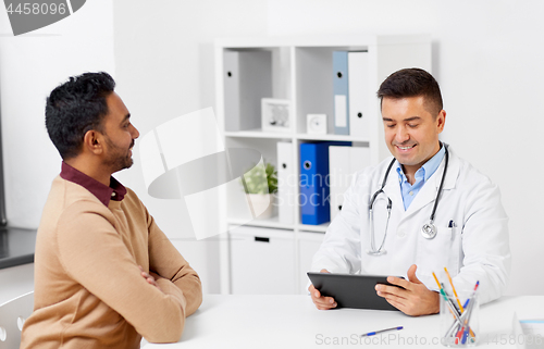 Image of doctor with tablet pc and male patient at hospital