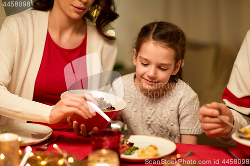 Image of happy family having christmas dinner at home