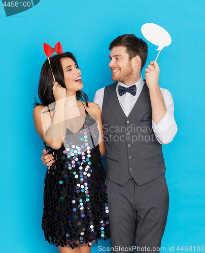 Image of happy couple with party props having fun