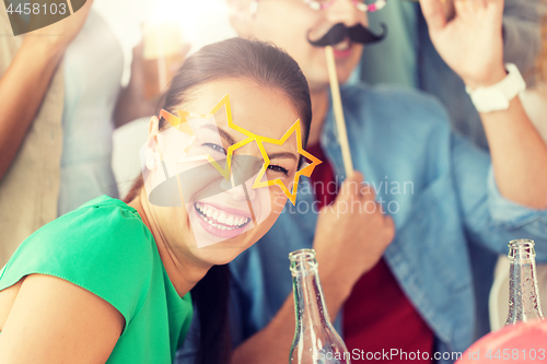Image of happy woman with friends having fun at party