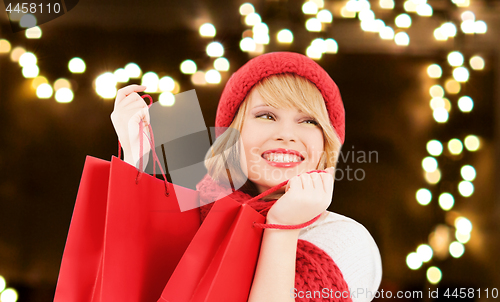 Image of happy young woman with shopping bags on christmas 