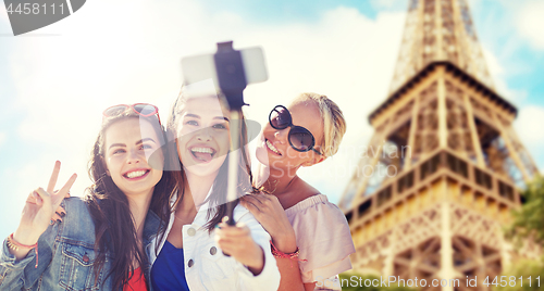 Image of group of smiling women taking selfie in paris