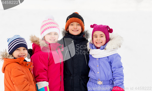Image of happy little kids in winter clothes outdoors