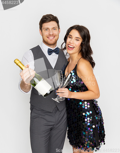 Image of happy couple with champagne and glasses at party