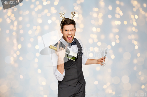 Image of man with bottle of champagne at christmas party