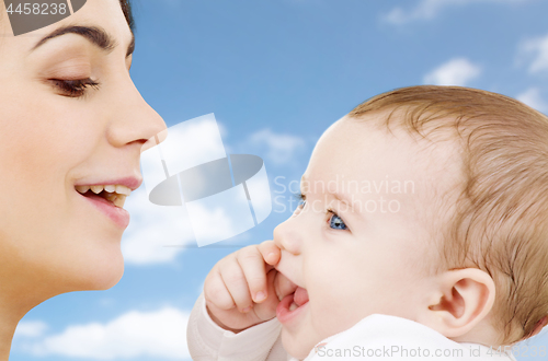 Image of mother with baby over sky background