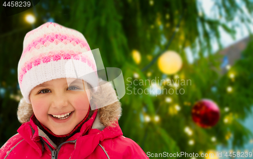 Image of happy little girl in winter clothes outdoors