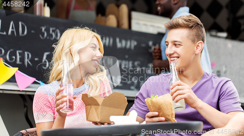 Image of friends eating and talking at food truck