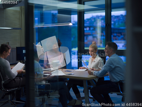 Image of Multiethnic startup business team in night office